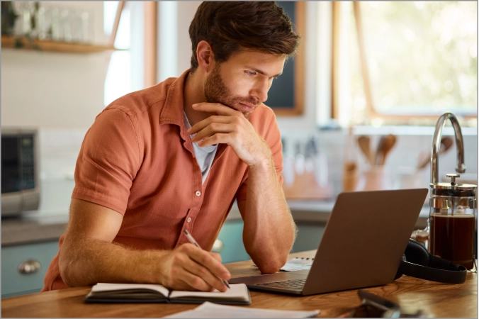 Serious man looking into laptop | Floors In Motion